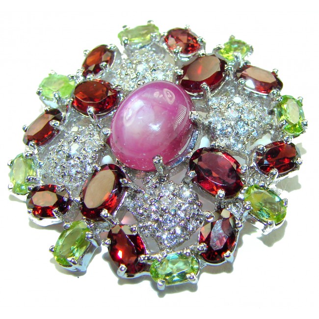 Excellent quality 5.2 carat Genuine Star Ruby .925 Sterling Silver handmade Pendant - Brooch - Close-up of star ruby jewelry with multicolored gemstones.