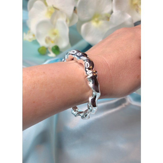 Fancy .925 Sterling Silver handcrafted Statement Italy made Bracelet - Sterling silver bracelet worn on wrist, close-up view, flower background.