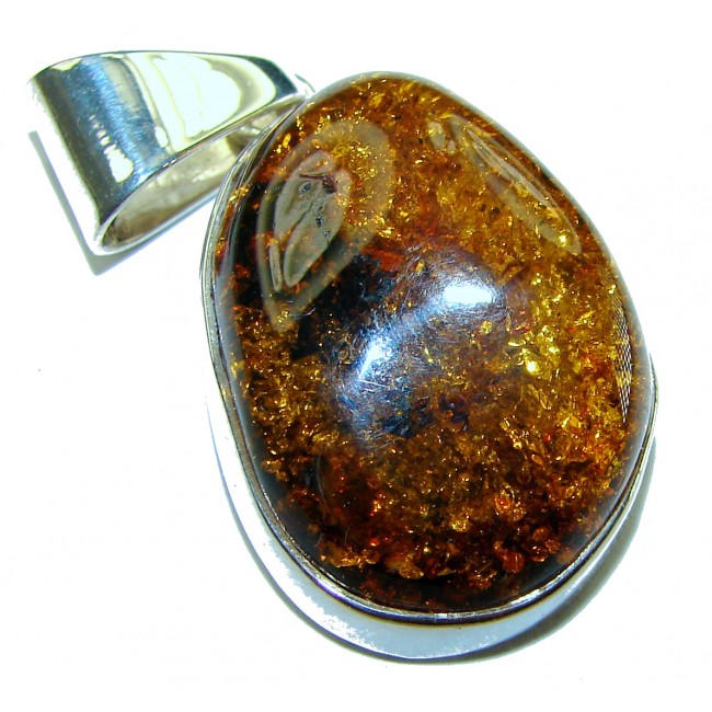 Golden natural Baltic Amber .925 Sterling Silver handmade Pendant - Close-up of Baltic amber and sterling silver pendant.