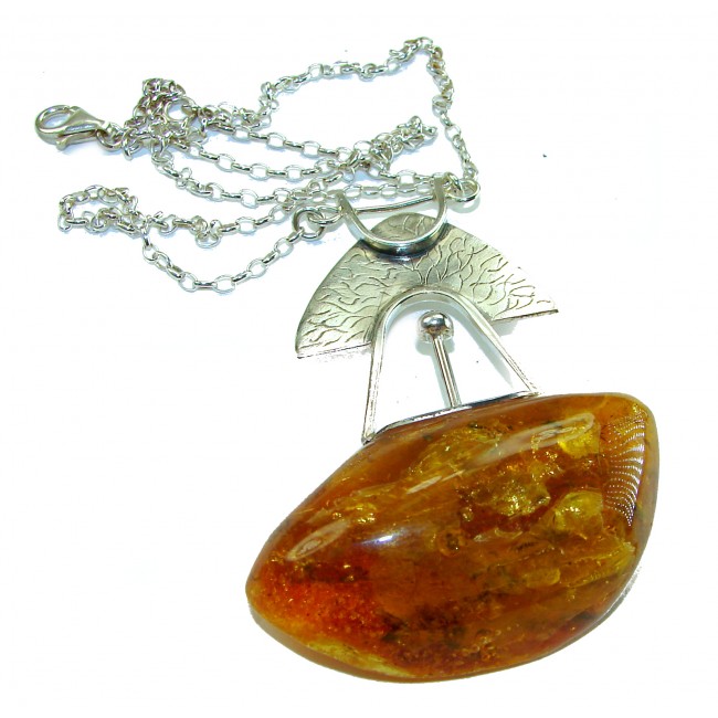 Natural large Beauty Golden Polish Amber .925 Sterling Silver handmade necklace - Amber pendant with silver chain, top view, featuring unique design.