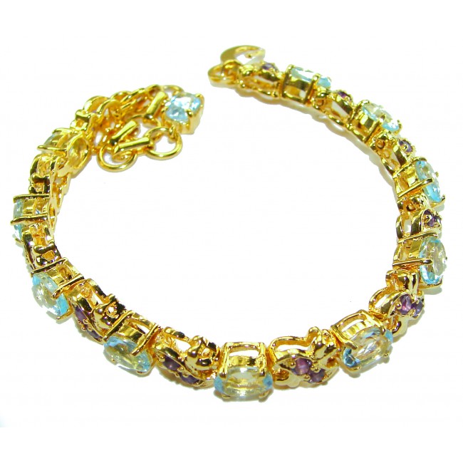 Genuine 24.5 carat Swiss Blue Topaz GARNET 14K Gold over .925 Sterling Silver handcrafted Bracelet - Gold bracelet with blue topaz and garnet, top view.