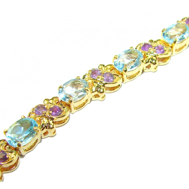 Genuine 24.5 carat Swiss Blue Topaz GARNET 14K Gold over .925 Sterling Silver handcrafted Bracelet - Gold bracelet with blue topaz and garnet, side view.