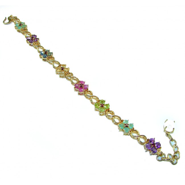 Luxurious 35.5 carat Genuine Ruby Emerald Sapphire 14 K Gold over .925 Sterling Silver Bracelet - Gold bracelet with colorful gemstones, angled view showing full length.