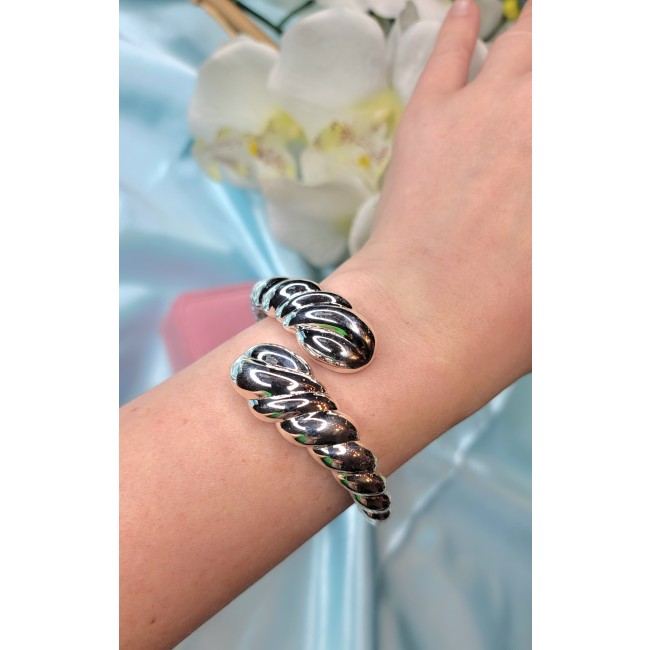 Italy made Bracelet in best quality highly polished .925 Sterling Silver - Bracelet worn on wrist, twisted design, shiny .925 silver, close-up view.