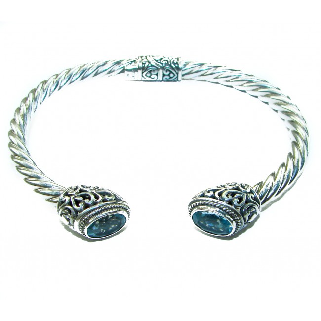 BLUE DREAMER 8.5 carat authentic Swiss Blue Topaz Floral Bracelet in .925 Sterling Silver - Silver bracelet with blue topaz, top view showing floral design.