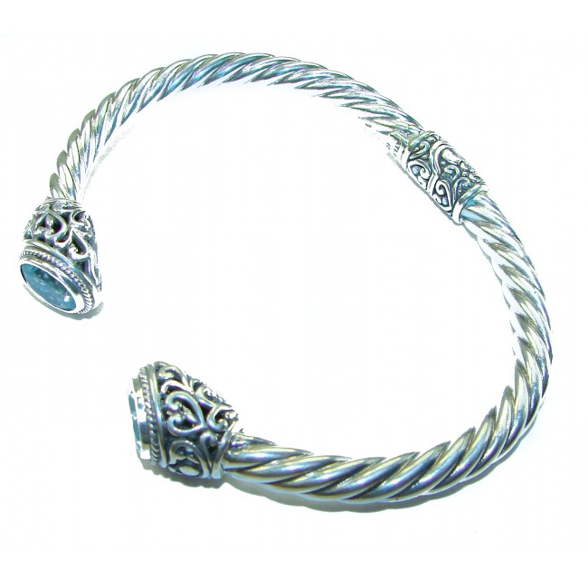 BLUE DREAMER 8.5 carat authentic Swiss Blue Topaz Floral Bracelet in .925 Sterling Silver - Silver bracelet with blue topaz and floral detail, angled view.