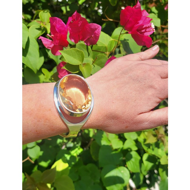 Simplicity 81.5 carat Genuine Lemon Quartz handcrafted .925 Sterling Silver Bracelet / Cuff - Lemon Quartz bracelet worn on wrist, with flowers in background.