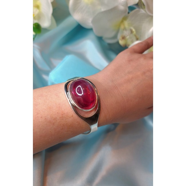 Bellezza Genuine 35.5 CARAT Star Ruby .925 Sterling Silver HUGE Bracelet / Cuff - Ruby bracelet worn on wrist, floral background.