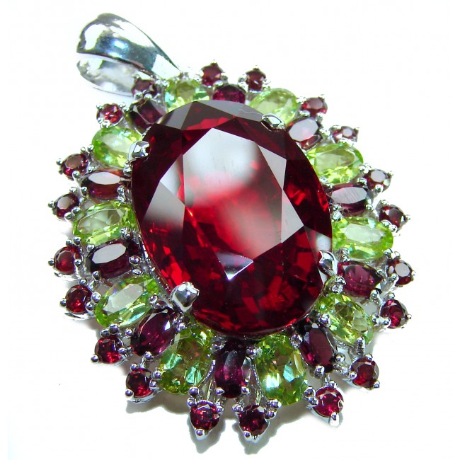 Victorian style 28.5 carat Authentic Ruby .925 Sterling Silver handcrafted Pendant - Close-up of Victorian style ruby pendant with green gemstone accents.