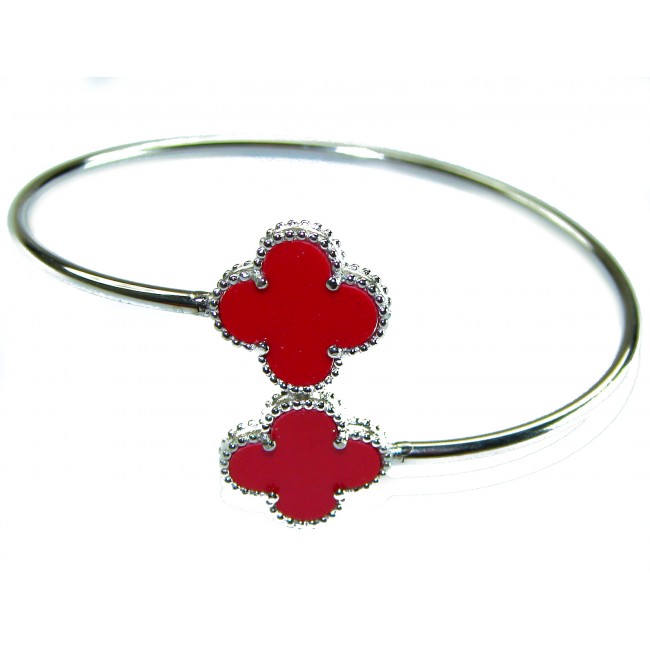 A Red four-leaf clover Coral .925 Sterling Silver handcrafted Bracelet - Silver bracelet with red clover motifs, top view.