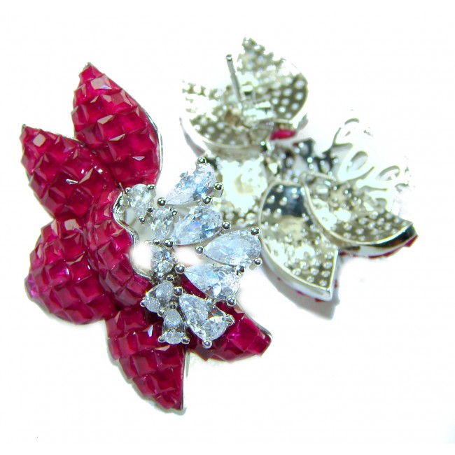 Magnificent Jewel 15.5 carat Ruby .925 Sterling Silver handcrafted incredible earrings - Close-up of ruby and sterling silver jewelry with clear gemstones.