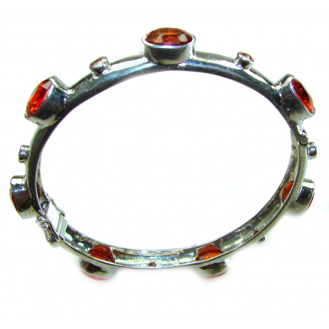 Red Galaxy Spectacular 25.2 carat authentic Ruby .925 Sterling Silver handmade bangle Bracelet - Aerial view of silver bracelet with red gemstones.