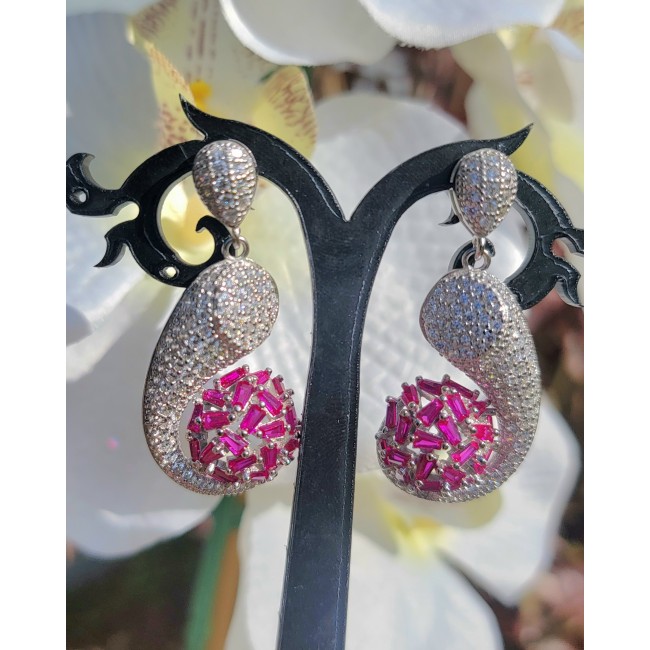 Pure Luxury 22.2 carat natural Ruby .925 Sterling Silver handmade Statement earrings - Close-up of ornate ruby and silver drop earrings on display.
