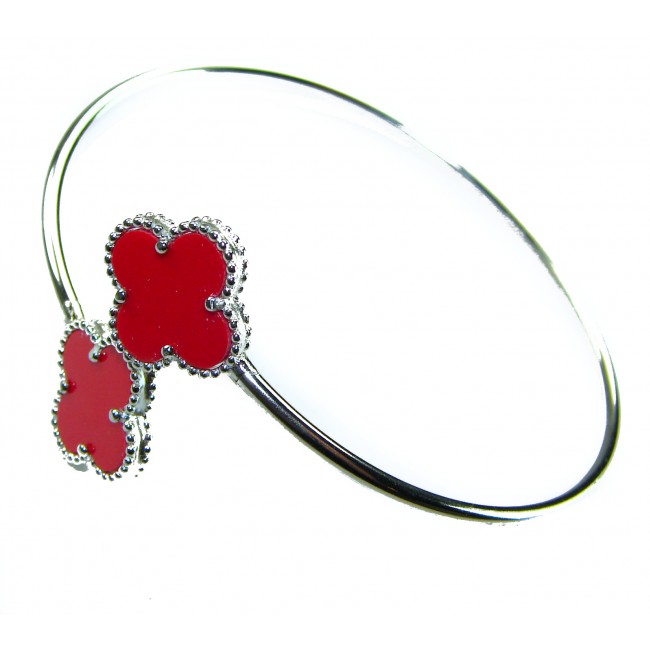 A Red four-leaf clover Coral .925 Sterling Silver handcrafted Bracelet - Red clover coral bangle, sterling silver, close-up view.
