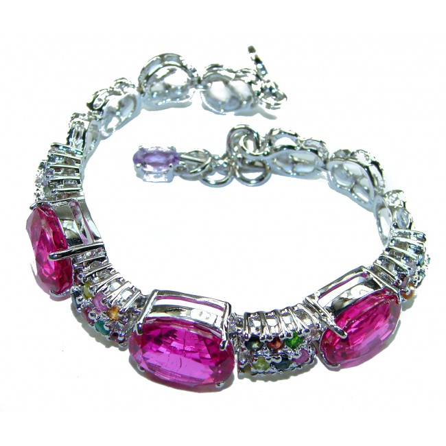 Tiffany - Unapologetically stunning Fuchsia Pink 125.5 carat Pink Sapphire RHODIUM OVER .925 Sterling Silver handcrafted Heavy Bracelet - Bracelet with large pink stones, angled side view.