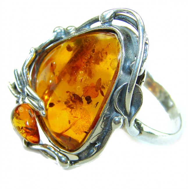Beauty of the Nature Baltic Amber .925 Sterling Silver handcrafted ring; s. 7 - Baltic amber sterling silver ring, stone close-up, intricate metal design.