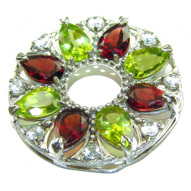 Happiness Authentic 35.5 carat Peridot Garnet .925 Sterling Silver handmade Statement Pendant - Close-up of a gemstone brooch with green and red stones and silver setting.