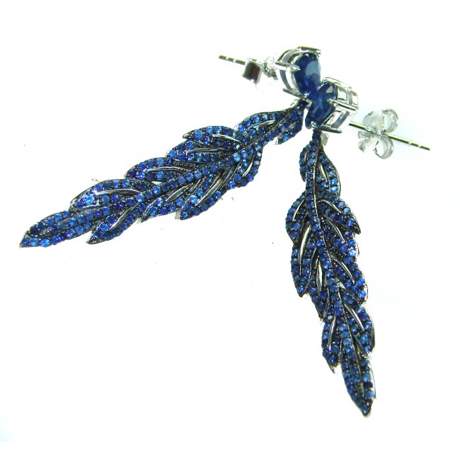 Giovanna - Authentic oval cut 9.9 carat Sapphire .925 Sterling Silver handcrafted earrings - Blue sapphire feather earrings on white background, side view.
