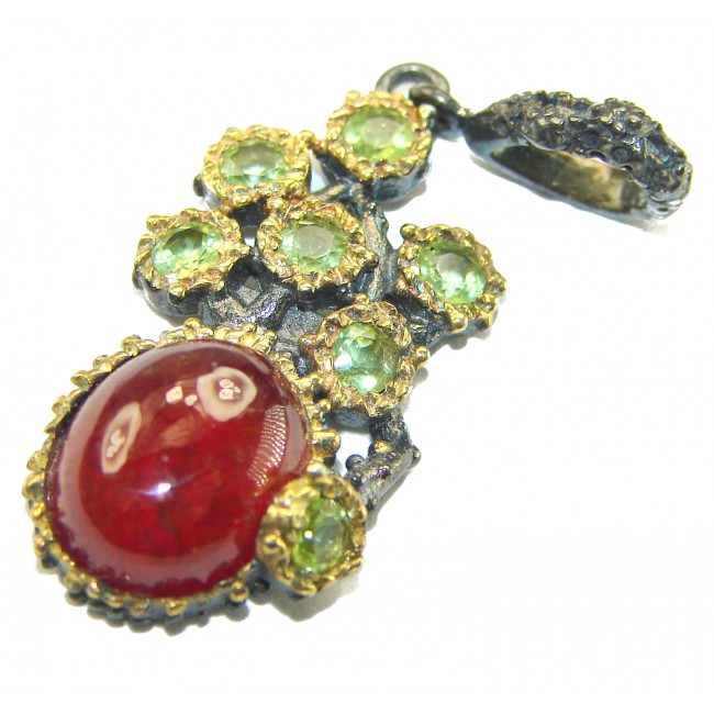 Genuine 4.5 carat Ruby BLACK RHODIUM OVER .925 Sterling Silver handmade Pendant - Close-up of ruby pendant with green gemstones and black rhodium detailing.