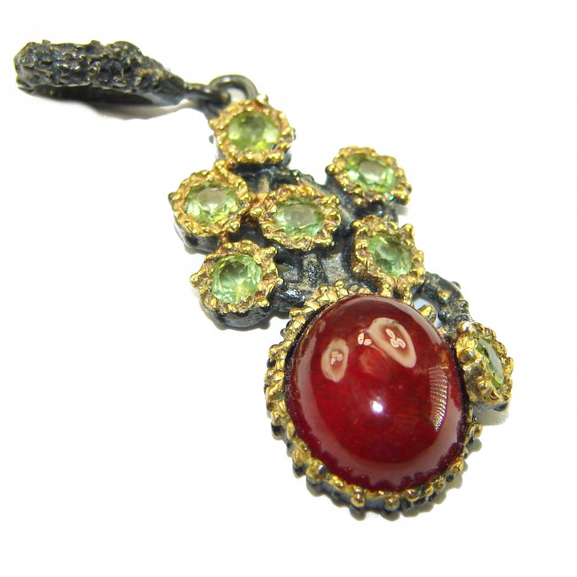 Genuine 4.5 carat Ruby BLACK RHODIUM OVER .925 Sterling Silver handmade Pendant - Close-up of ruby pendant with green gemstones in black rhodium setting.