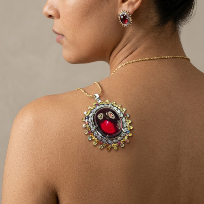 Oversized! Rare finding! Deluxe 67.2 carat authentic Red Topaz rhodium over .925 Sterling Silver handmade Statement Pendant - Side view, large red gemstone necklace and earring worn on shoulder.