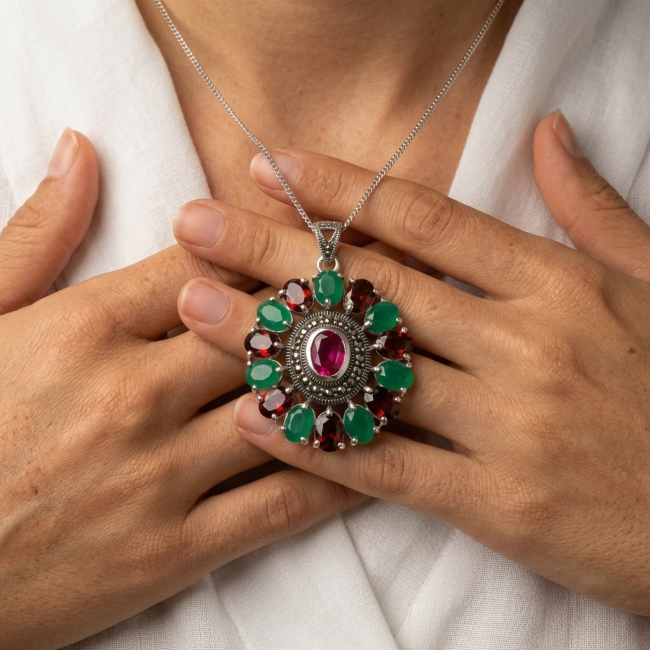 Giovanna 22.2 carat authentic Ruby Emerald Marcasite .925 Sterling Silver handmade Pendant - Necklace with large ruby and emerald worn on chest, hands touching pendant.