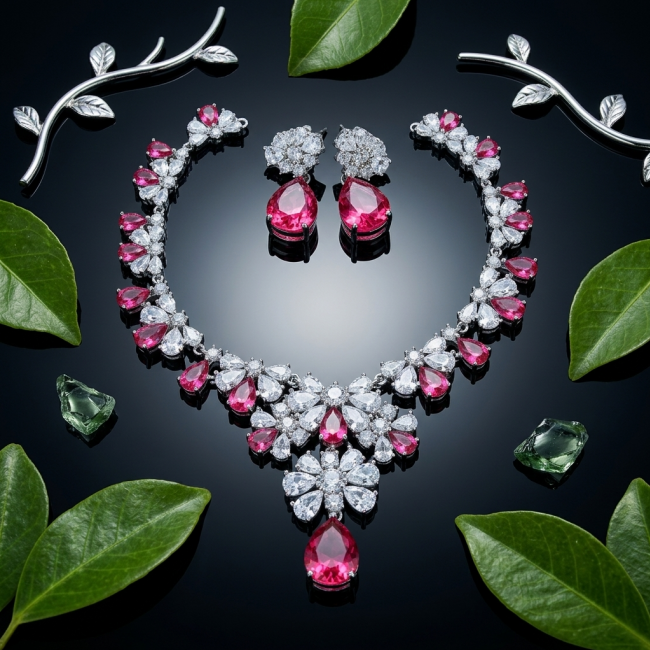 Giovanna - Magnificent Jewel 6.5 carat Ruby .925 Sterling Silver handcrafted incredible earrings - Necklace and earrings set with rubies, top view, surrounded by leaves.