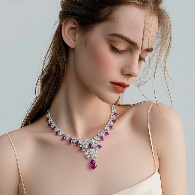 Giovanna - Magnificent Jewel 22.5 carat Ruby .925 Sterling Silver handcrafted incredible Statement necklace - Model wearing "Giovanna" necklace, side view showcasing ruby and diamonds.