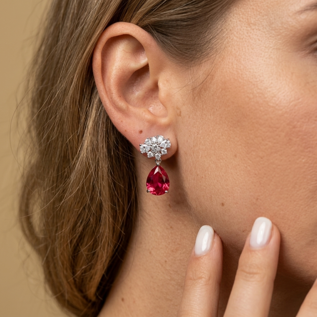 Giovanna - Magnificent Jewel 6.5 carat Ruby .925 Sterling Silver handcrafted incredible earrings - Earring with red ruby drop and diamonds, worn on ear, side view.