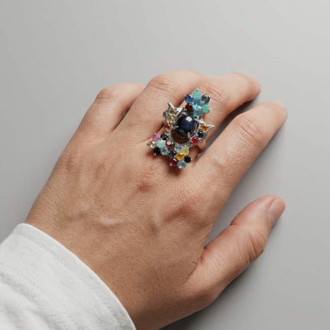 Classic design Genuine 16.5 carat Star Sapphire .925 Sterling Silver handcrafted Ring size 7 - Star Sapphire ring with multicolored gems worn on hand, top view.