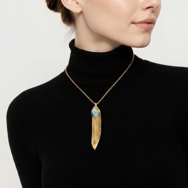 Natural Leaf Larimar 14K Gold over .925 Sterling Silver handmade - Necklace worn on model, gold leaf and blue stone, black turtleneck background