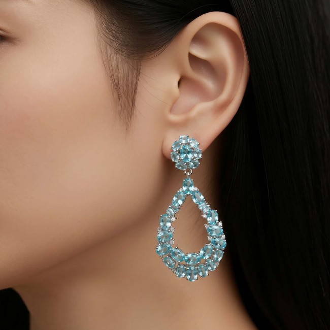 Serenity 18.5 carat genuine Swiss Blue Topaz .925 Sterling Silver handmade Large Statement earrings - Side view of Serenity Swiss Blue Topaz earrings worn on ear.