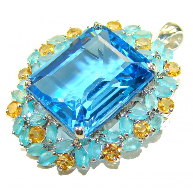 Majestic - Vintage style oval cut 46.8 carat Swiss Blue Topaz .925 Sterling Silver DIPPED IN RHODIUM handmade Pendant Brooch - Close-up of oval cut Swiss Blue gemstone with turquoise and yellow accents.