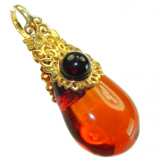 Prehistoric Authentic Baltic Amber 18K Gold over .925 Sterling Silver beautifully handcrafted Pendant - Amber and gold pendant, side view, showcasing intricate design details.
