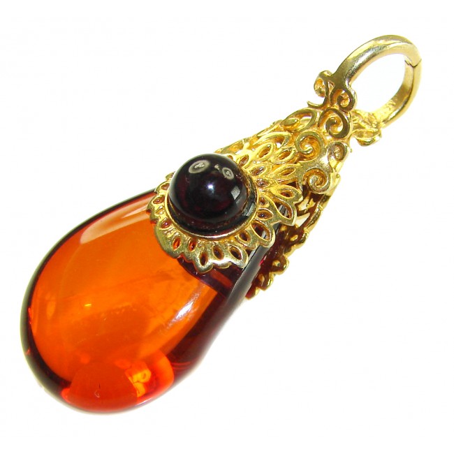Prehistoric Authentic Baltic Amber 18K Gold over .925 Sterling Silver beautifully handcrafted Pendant - Close-up of Baltic amber pendant with gold filigree and black stone.