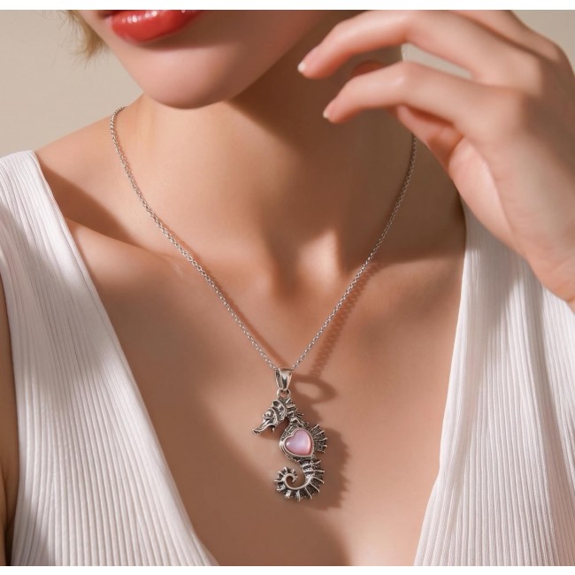 Seahorse Excellent quality 0.9 carat Pink Opal .925 Sterling Silver handcrafted Pendant - Seahorse necklace with pink opal worn on neck, close-up view.