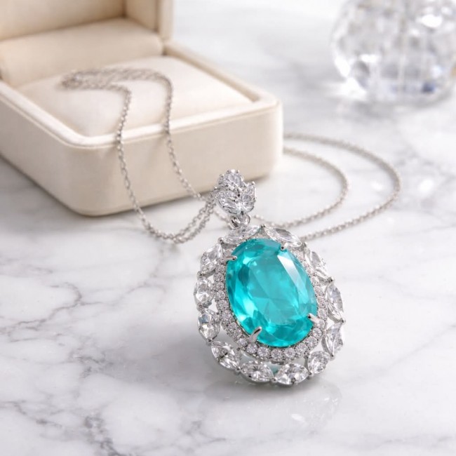 Wonderland 15.8 carat classic oval cut Paraiba Tourmaline .925 Sterling Silver Handcrafted Statement necklace - Close-up of Wonderland oval cut Paraiba Tourmaline necklace on marble