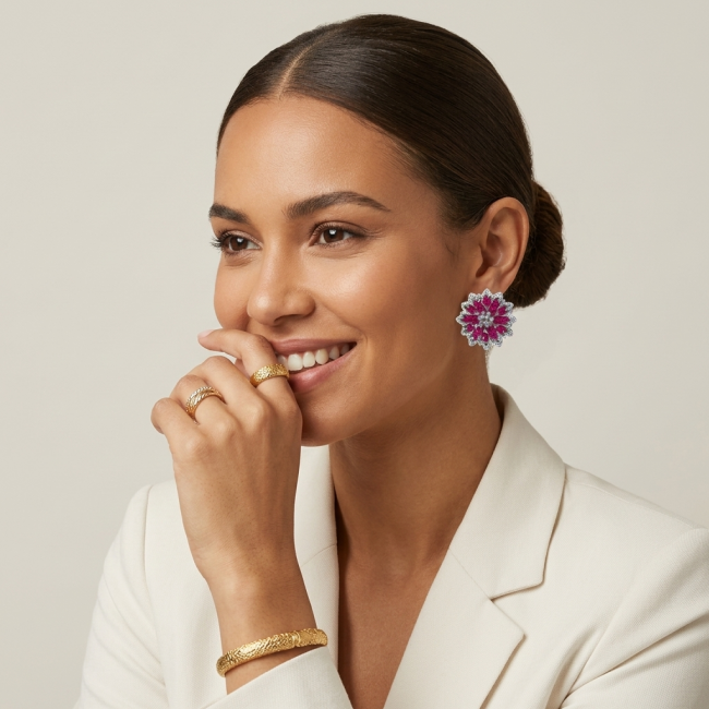 Bella Rosa Genuine 22.8 carat Ruby .925 Sterling Silver dipped in rhodium Statement brilliantly handcrafted earrings - Woman wearing Bella Rosa earrings, rings, and bracelet, side view.