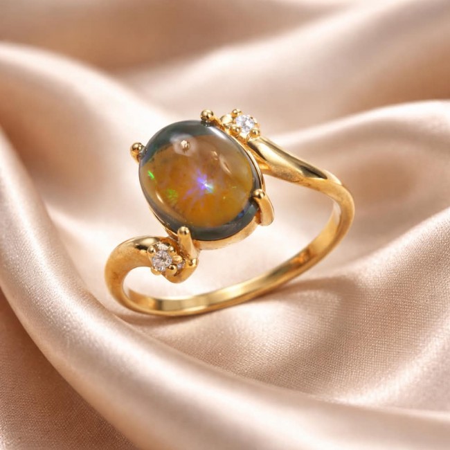 A Milky Way Genuine 4.8 carat Black Opal 18K Gold over .925 Sterling Silver handmade Ring size 7 1/2 - Close-up of Milky Way black opal ring on silk fabric background.
