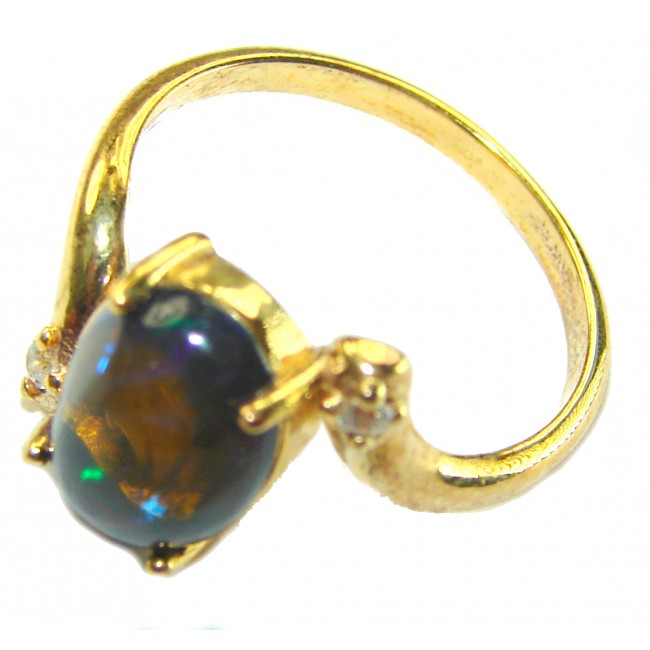 A Milky Way Genuine 4.8 carat Black Opal 18K Gold over .925 Sterling Silver handmade Ring size 7 1/2 - Gold ring with black opal, side view showing stone and setting detail.