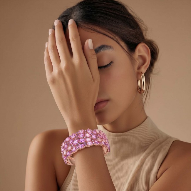 Luxurious 85.4 carat Pink Sapphire 22K real ROSE Gold over .925 Sterling Silver handcrafted Bracelet - Pink sapphire bracelet on hand, side view with gold hoop earrings.