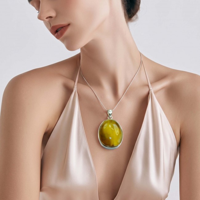 Prehistoric Authentic Baltic Amber .925 Sterling Silver beautifully handcrafted Pendant - Model wearing Baltic amber pendant on satin dress, side view.