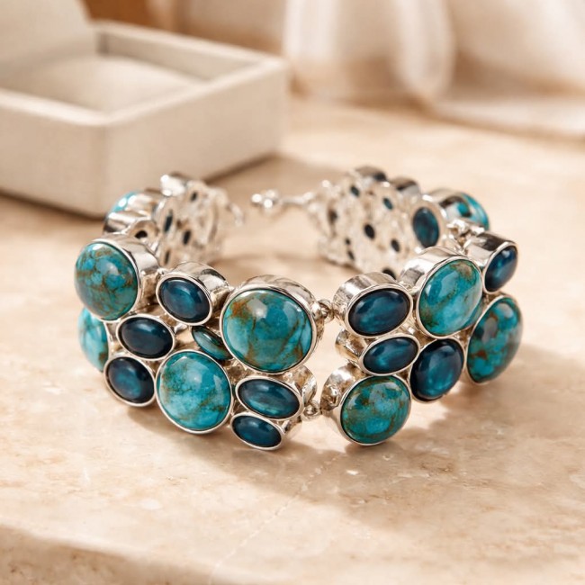 Luxurious one of a kind 65.8 carat Copper Turquoise .925 Sterling Silver handmade Bracelet - Copper turquoise bracelet on a table, side view.
