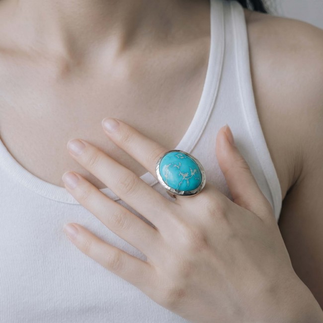 RARE KINGMEN Turquoise .925 Sterling Silver handmade Large ring size 11 - Turquoise ring on hand, close-up view against white top.