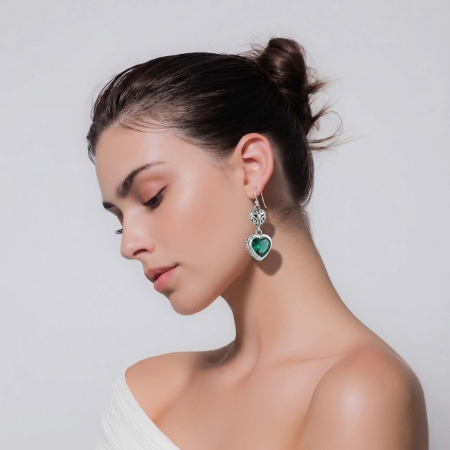 Green Heart Authentic 6.5 CARAT Chrome Diopside .925 Sterling Silver handcrafted earrings - Side view of green heart chrome diopside earrings worn by a model.