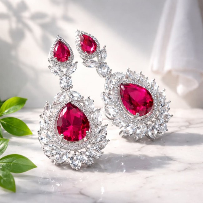 Tiffany - authentic 7.5 carat Ruby .925 Sterling Silver dipped in rhodium handcrafted Statement Earrings - Ruby earrings in Sterling Silver, front view on marble surface.