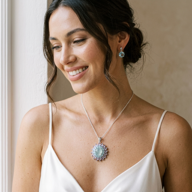 Royal quality genuine 19.8 carat Prehnite rhodium over .925 Sterling Silver handcrafted Pendant - Woman wearing Prehnite necklace and earrings, close-up view