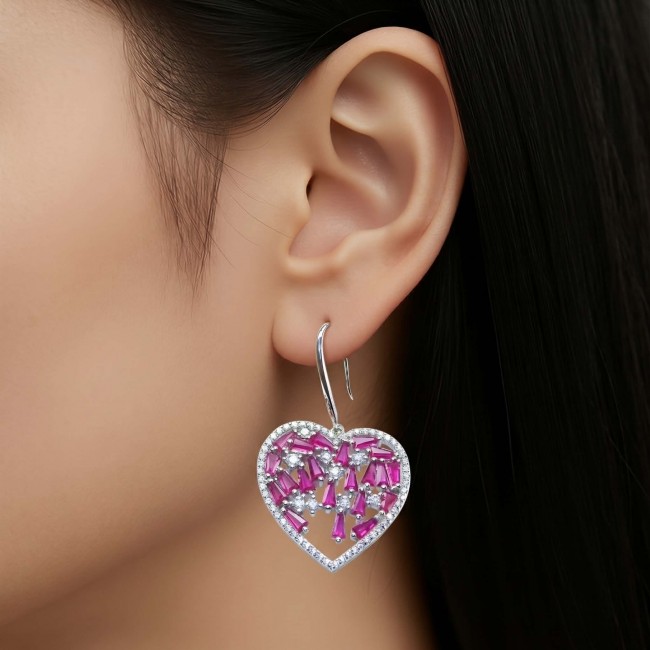 Precious Hearts - authentic 12.5 carat Mozambique Ruby .925 Sterling Silver dipped in rhodium handcrafted Statement Earrings - Close-up of heart-shaped ruby earring worn on ear