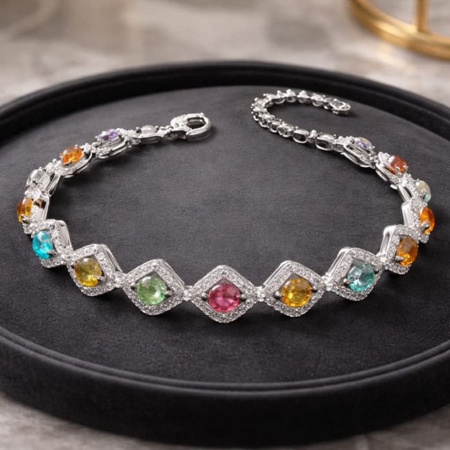 Authentic 22.5 carat Brazilian Watermelon Tourmaline 14K White Gold over .925 Sterling Silver handmade Bracelet - Bracelet with colorful gemstones on a display tray, angled view