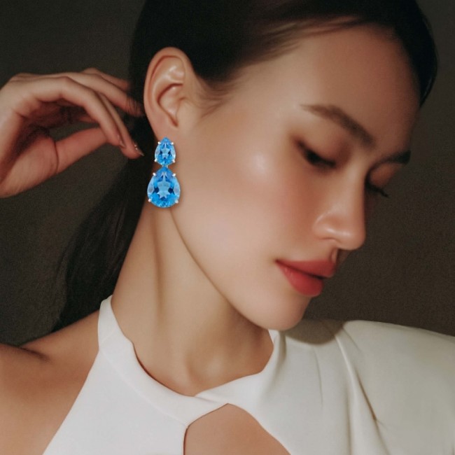 Atlantica 36.7 carat Swiss Blue Topaz RHODIUM OVER .925 Sterling Silver Handcrafted LARGE Statement earrings - Side view of 36.7 carat Swiss Blue Topaz earrings worn by model.